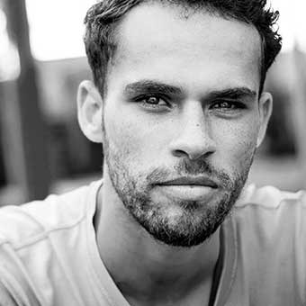A black and white photo of a man with a beard, possibly a diesel mechanic.